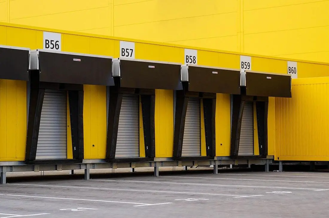 Row of industrial loading dock doors at a light manufacturing property