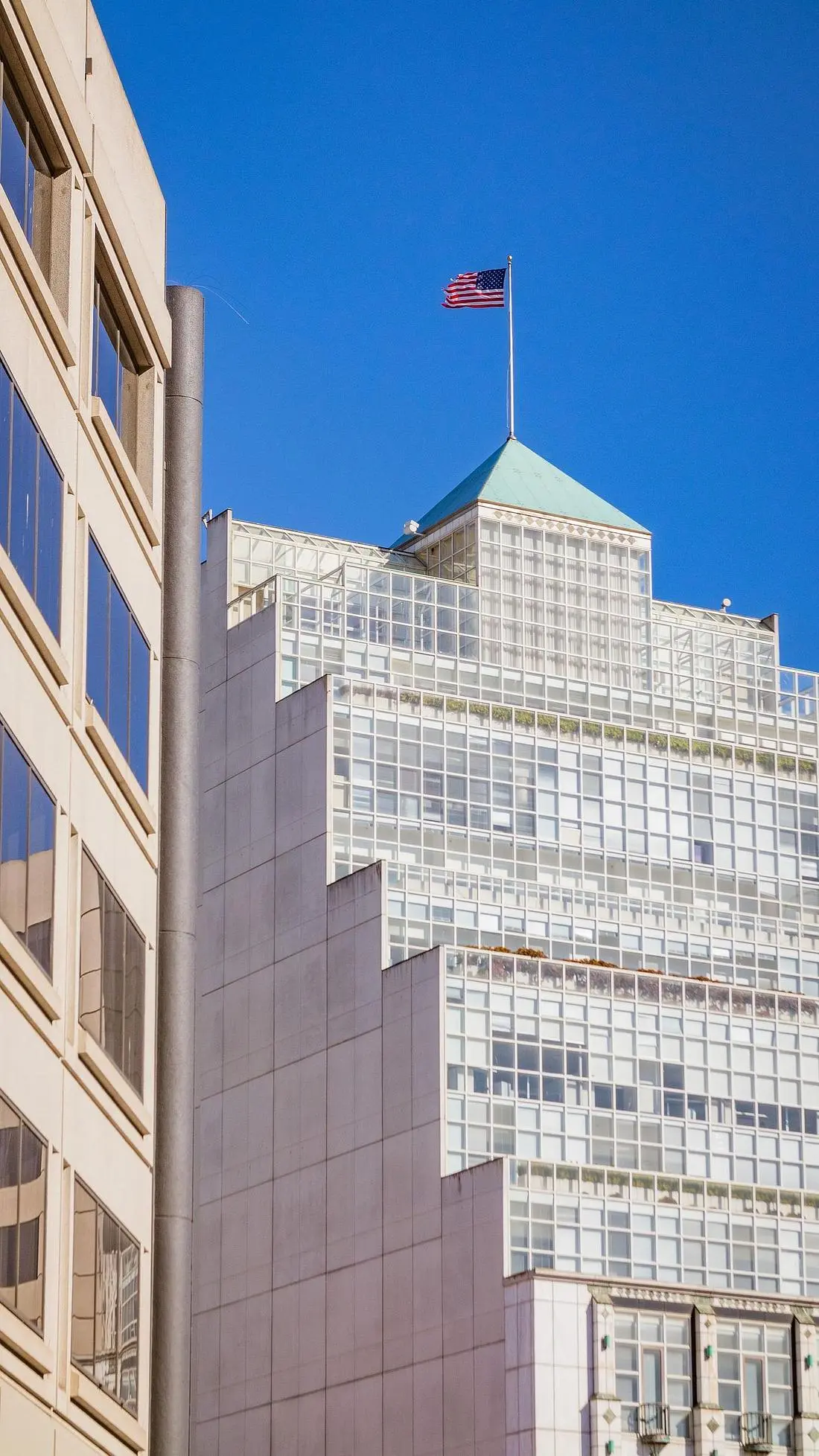 Professional office building with American flag under a clear sky