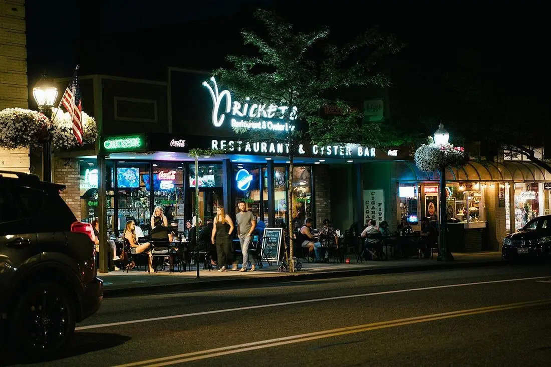 American restaurant and bar storefront lit at night