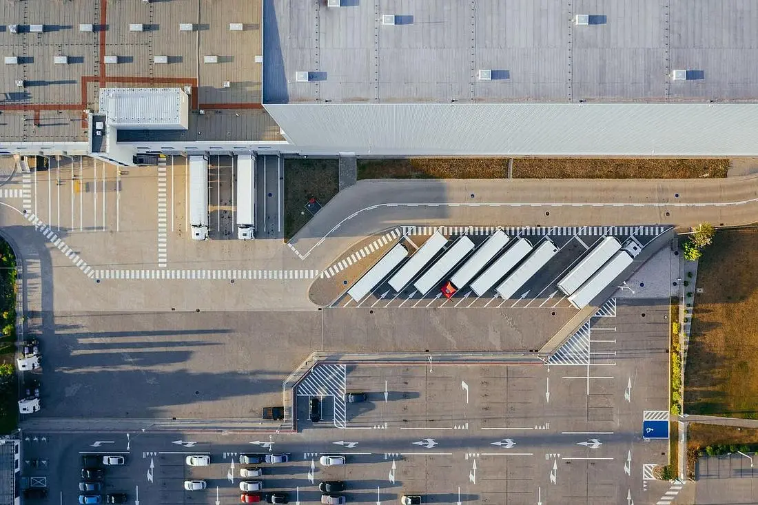 Aerial view of warehouse buildings with loading docks and trucks
